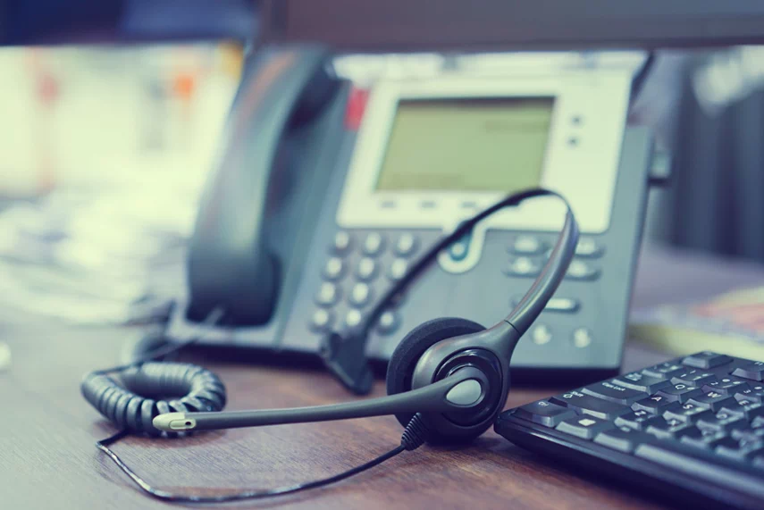 Phone headset and IP phone in the background