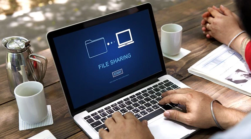 Man working on laptop and sharing files.