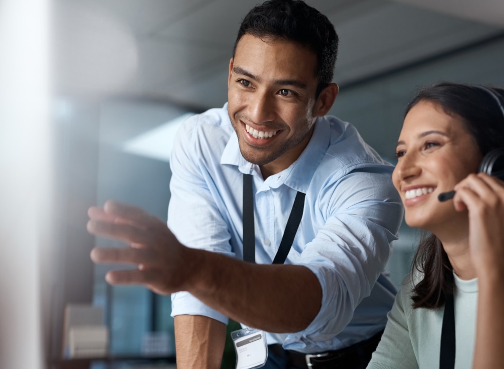 Happy and smiling colleagues looking at monitor