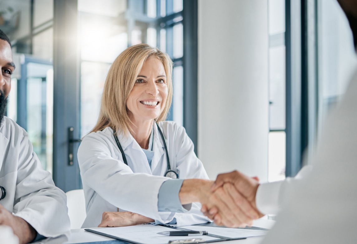 Doctor handshake with the IT Support Team