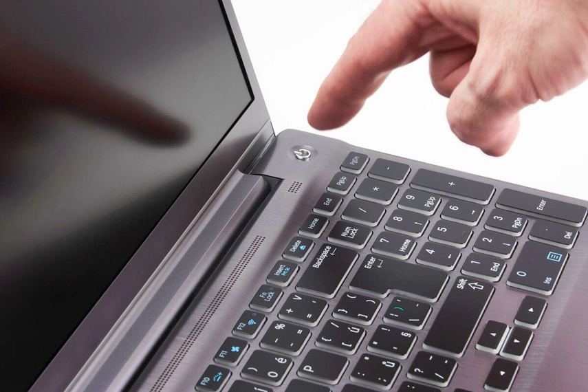 Close look of finger how to turn off the laptop.