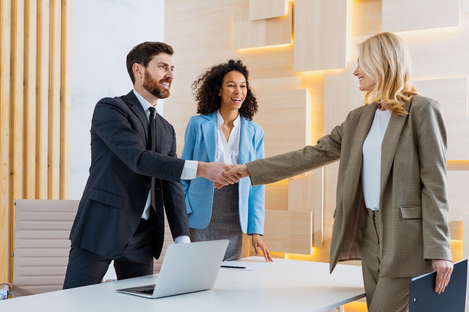 The logistics company director makes a handshake with the IT Support Team.