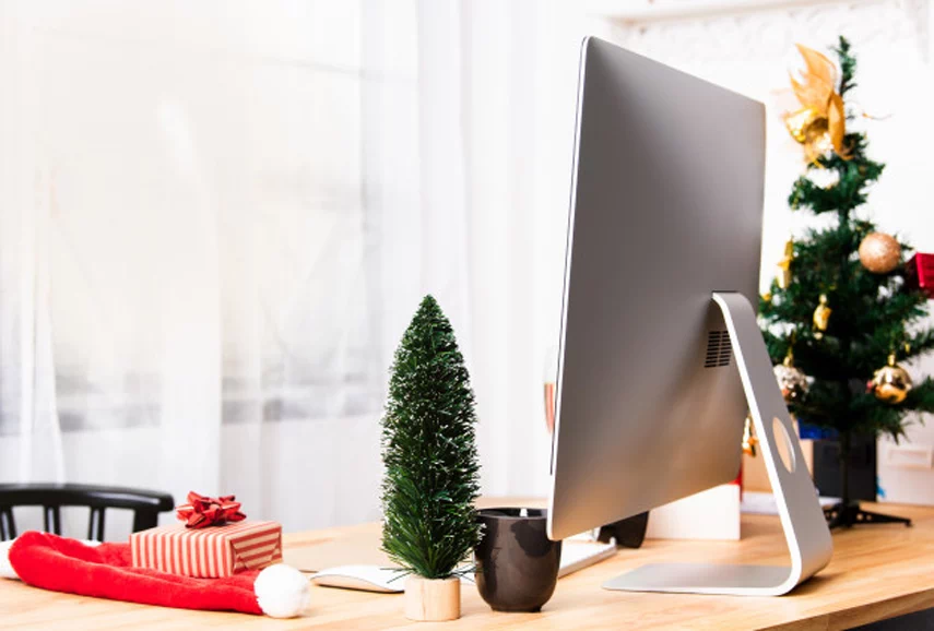 Office desk with small Christmas tree.