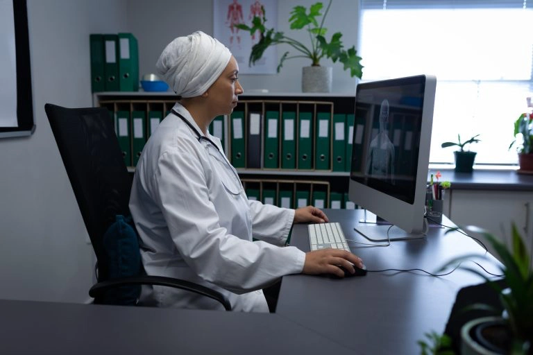 Side view of matured mixed race female doctor work.