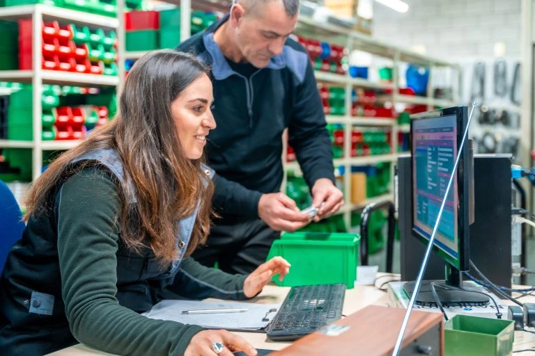 Workers using computer to do inventory in a logistcs center.