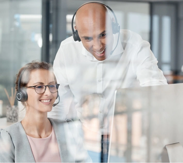 Teammates are wearing headsets and watching on the monitor.